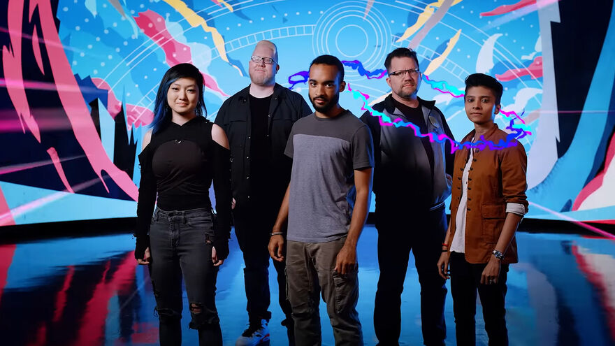 Five people posing for a photo with a colourful background. 