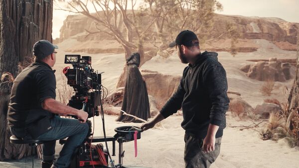 two men filming on a virtual production set
