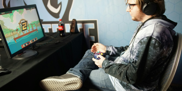 Man playing video game in home office